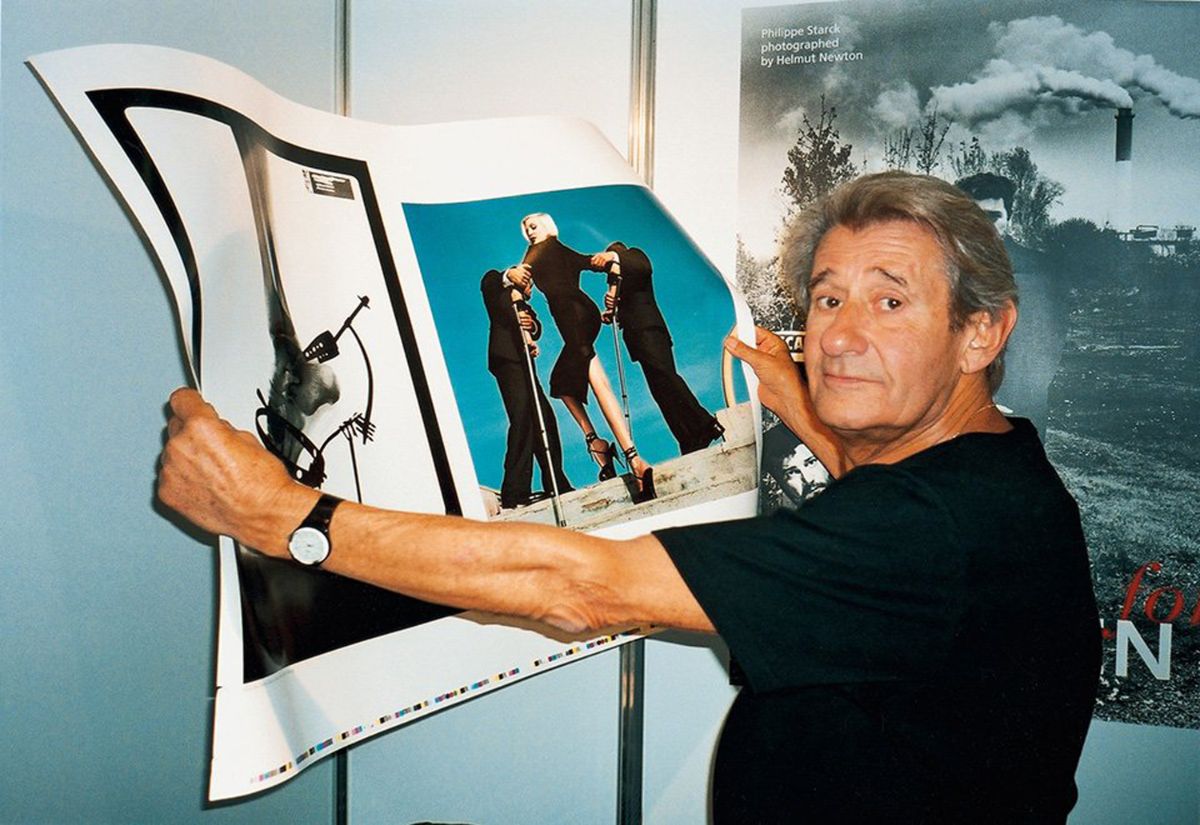 Helmut Newton checks a printing sheet during Frankfurt Book Fair, 1999. The print he holds is Nadja wearing Dolce & Gabbana for American Vogue Monte Carlo, 1995 Courtesy Taschen