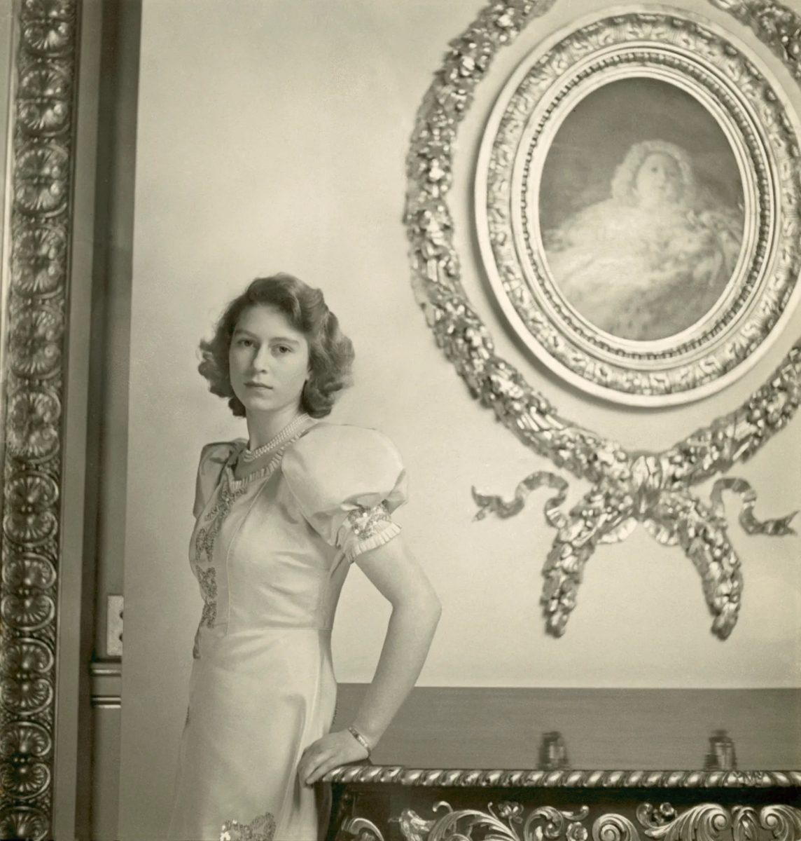 Queen Elizabeth II as a princess in 1947, wearing a dress with puffed shoulders. Photographed by Cecil Beaton