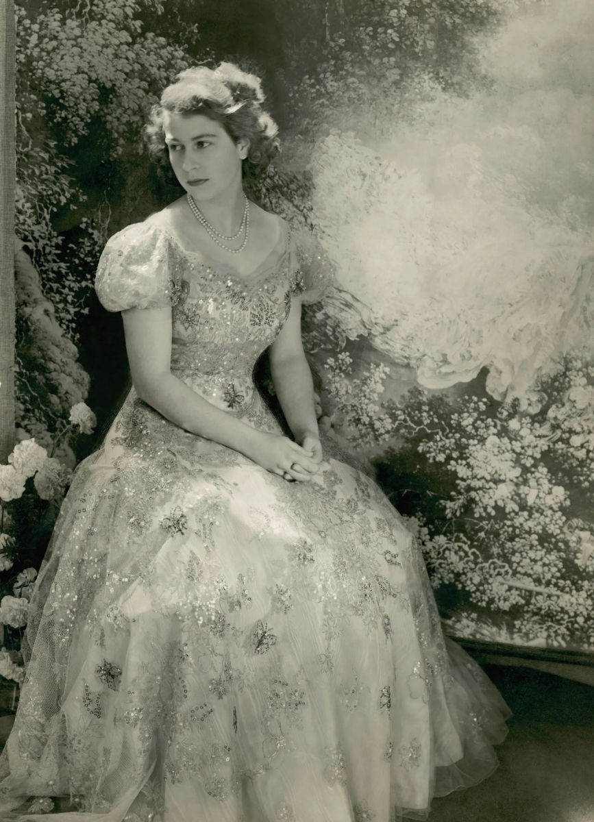 Queen Elizabeth as a princess in 1946, wearing a moire satin dress with a tulle, sequin embroidered overlay. Photographed by Cecil Beaton